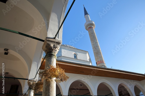 The internal courtyard of Emperor's Mosque, located in Bistrik district, with arches, columns and the minaret in the background, Sarajevo, Bosnia and Herzegovina photo