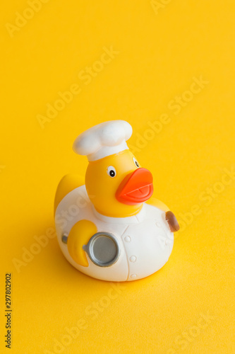 Fotografie Yellow cook rubber duck with kitchen utensils