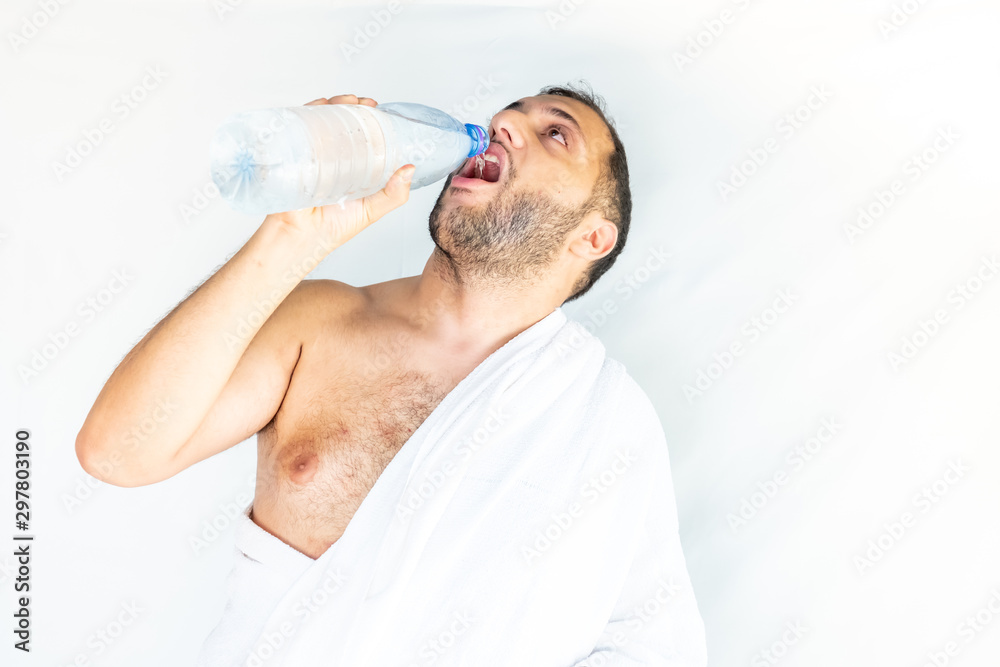Muslim man drinking some water after finishing haj Muslim man drinking some water after finishing haj