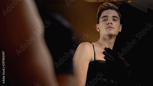 Foto Trans man in black dress enjoying his feminine image in mirror, proud homosexual