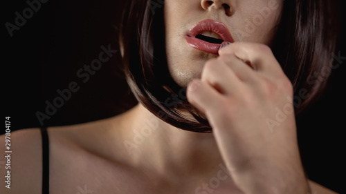 Obraz na płótnie Brunette male transgender applying lipstick, gay makeup quality cosmetics