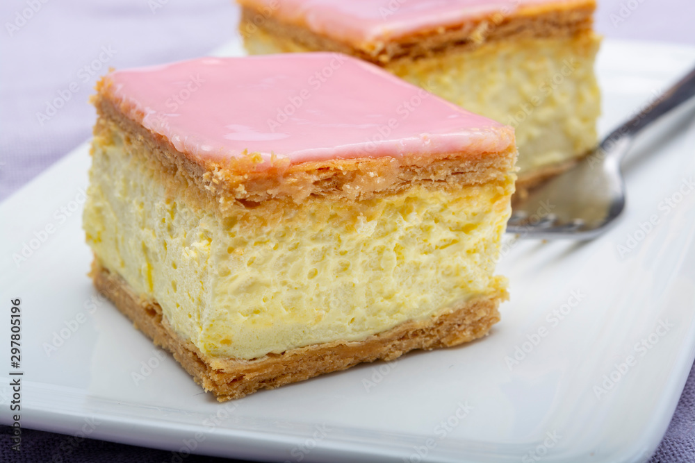 Tompoes or tompouce, iconic pastry in Netherlands and Belgium made from puff dough, icing, cream Tompoes or tompouce, iconic pastry in Netherlands and Belgium made from puff dough, icing, cream