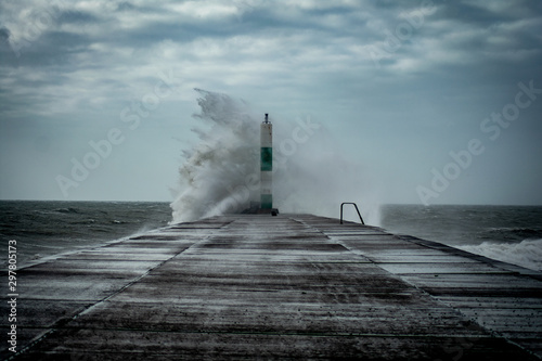 Strong winds create big waves that batter into Aberystwyth, Mid Wales sea front during the Storm season.