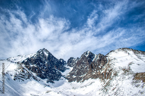 Snowy Lomnicky peak on a sunny day with a blue sky © Nikolett