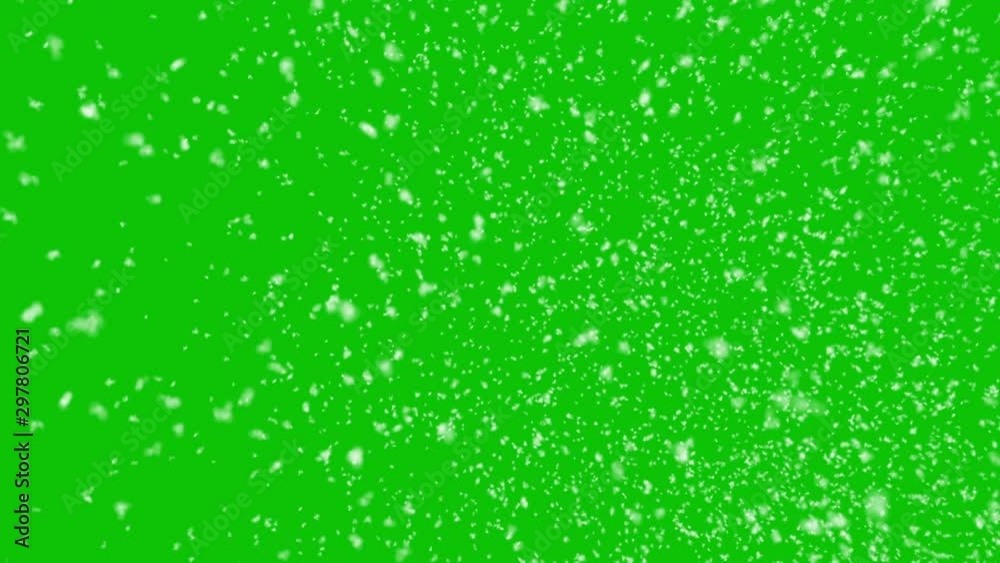 Isolated realistic snow falling with horizontal wind on a green screen background