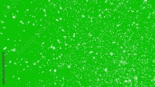 Isolated realistic snow falling with horizontal wind on a green screen background
