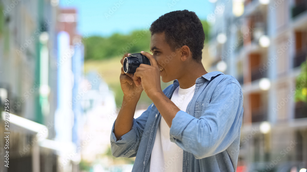 Cheerful african american guy taking photos on camera outdoors, favorite hobby Cheerful african american guy taking photos on camera outdoors, favorite hobby