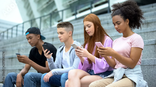 University students chatting smartphones online, lack communication, addiction