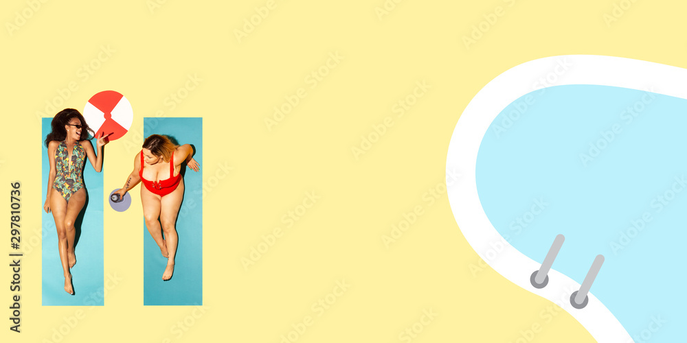 Top view of young caucasian model's resting on beach resort on blue and yellow background as an ocean and sand in bright swimsuit. Copyspace. Concept of summertime, party, chill, vacation, friendship Top view of young caucasian model's resting on beach resort on blue and yellow background as an ocean and sand in bright swimsuit. Copyspace. Concept of summertime, party, chill, vacation, friendship