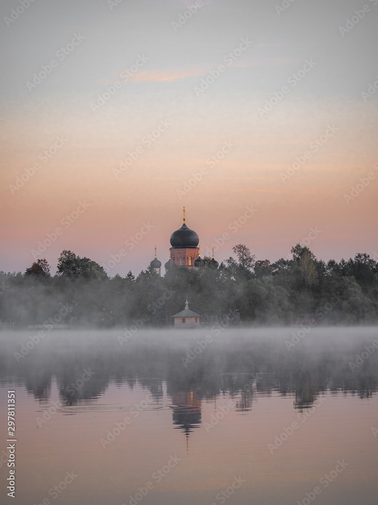 Vvedensky island monastery. Vladimir region. Misty daybreak on the lake.