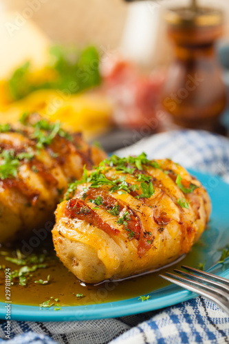 Baked potatoes in Swedish. Hasselback. Stuffed with cheese and bacon. Top view.