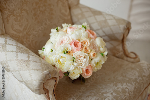 Beautiful flower beige pink purple roses, pink orchids, chrysanthemums and hortensias mixed and white eustomasbouquet on the brown sofa. photo