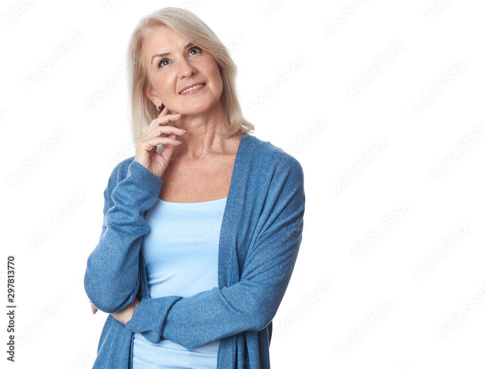 Thoughtful casual senior woman looking up - isolated Thoughtful casual senior woman looking up - isolated