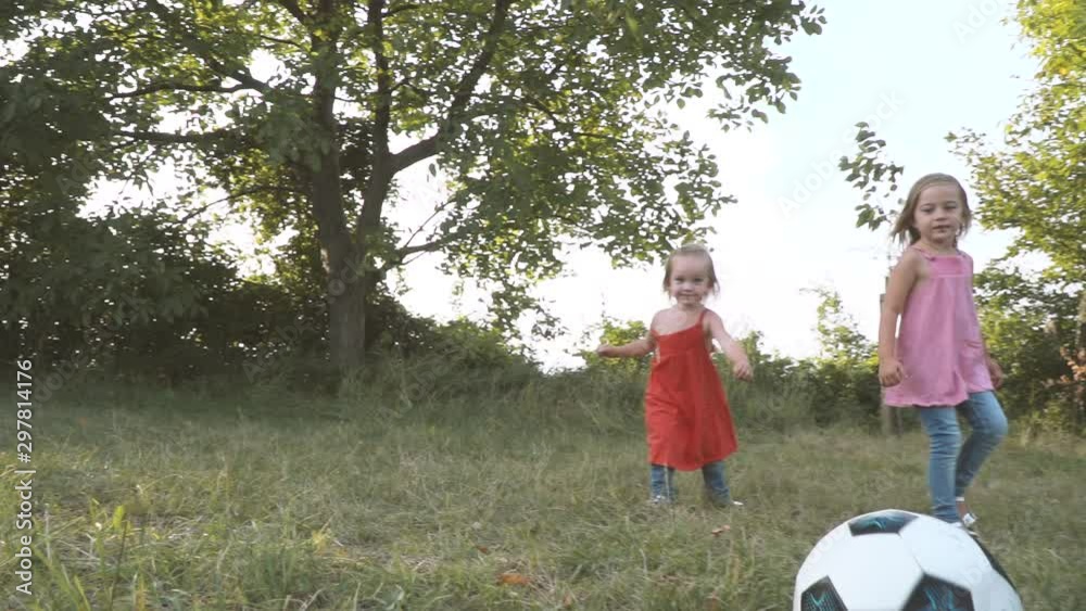 father is playing football with his two girls, daughters father is playing football with his two girls, daughters