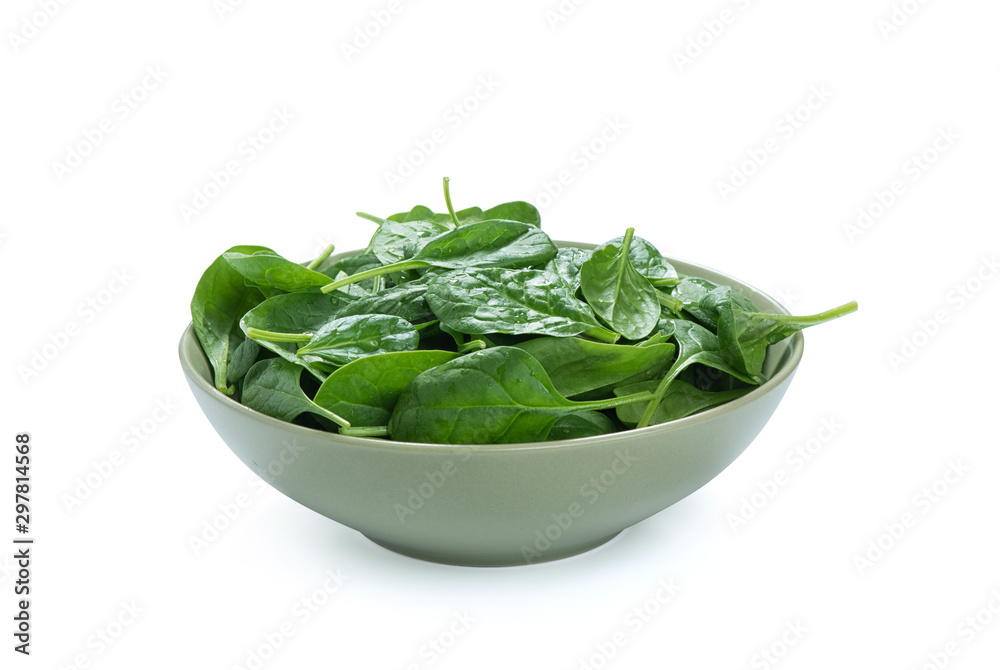 baby spinach leaves in a bowl isolated on white baby spinach leaves in a bowl isolated on white