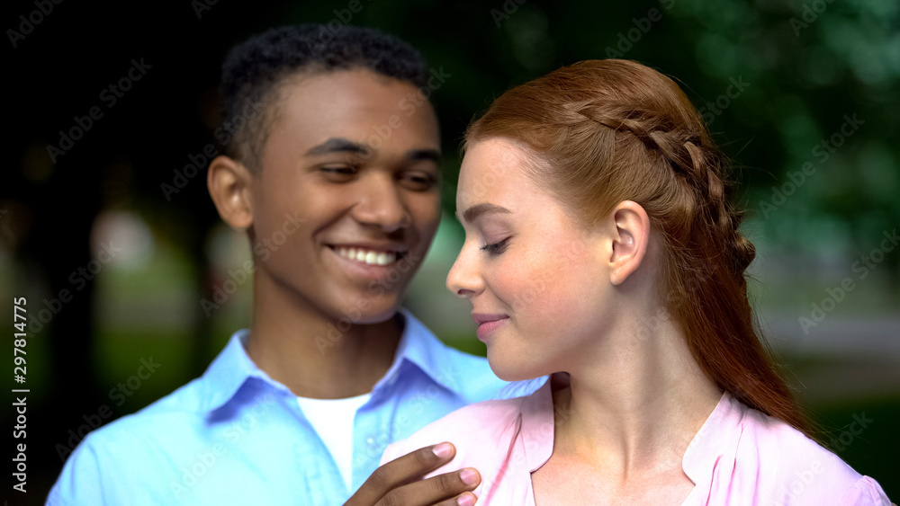 Beautiful mixed-race couple hugging looking at each other, tenderness and love Beautiful mixed-race couple hugging looking at each other, tenderness and love