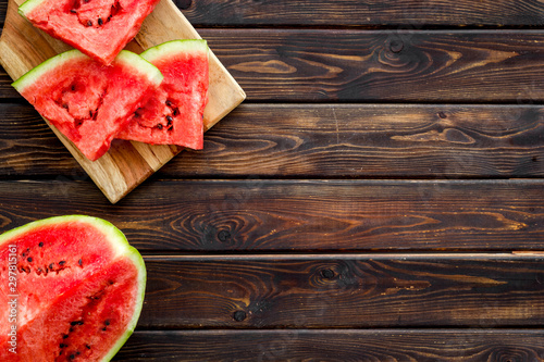 Pieces of watermelon on wooden background top view space for text