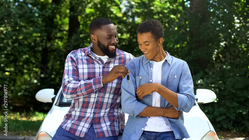 Photography Happy dad giving car key to son, permission to drive, parenthood trust, family