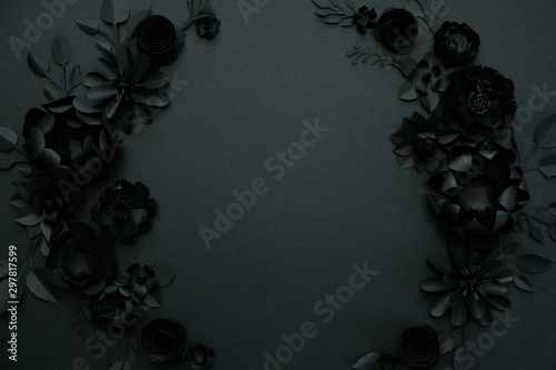 Black paper flowers on Black background. Cut from paper. photo