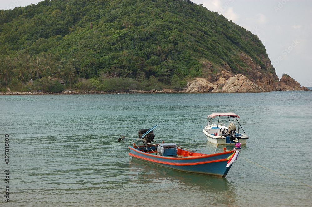 Two boats facing the Koh Ma island at Mae Haad Beach, Koh Phangan, Thailand