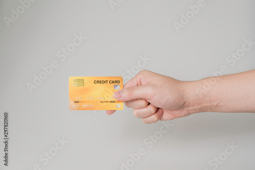 Finance Technology concept, Hand holding yellow crit card on white background and clipping path