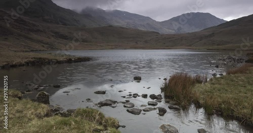 View from Styhead tarn towards Scafell Pike and Lingmell in the Lake District, UK. Timelapse. photo