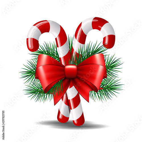 Christmas candy canes with red bow isolated on white.