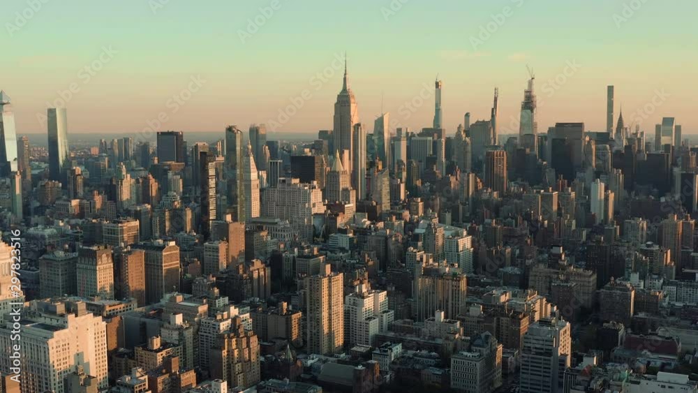 Flying backwards above Manhattan buildings, New York City at sunrise Flying backwards above Manhattan buildings, New York City at sunrise