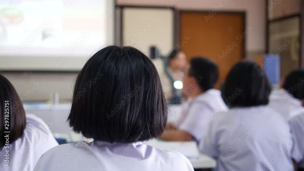 The Asian high school students in white uniform are studying in classroom. The Asian high school students in white uniform are studying in classroom.