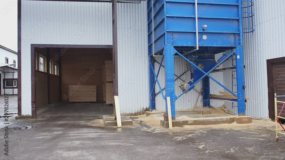 blue sawdust bin near woodwork plant warehouse slow motion blue sawdust bin near woodwork plant warehouse slow motion
