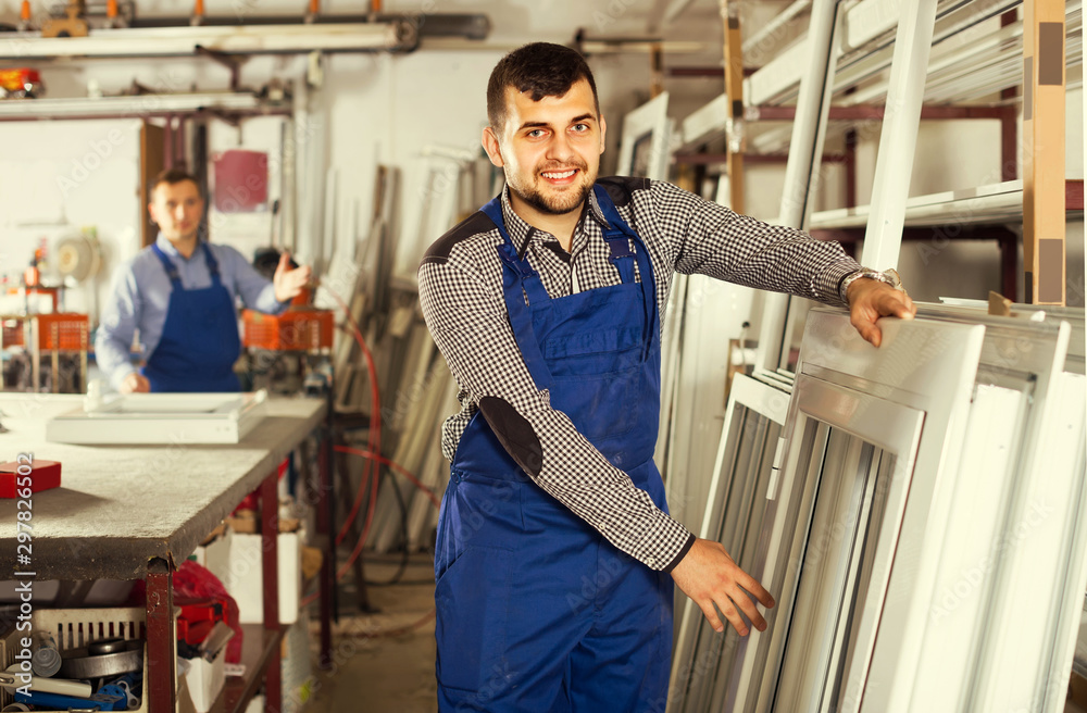 Obraz premium Production workers in coverall with different finished PVC pro