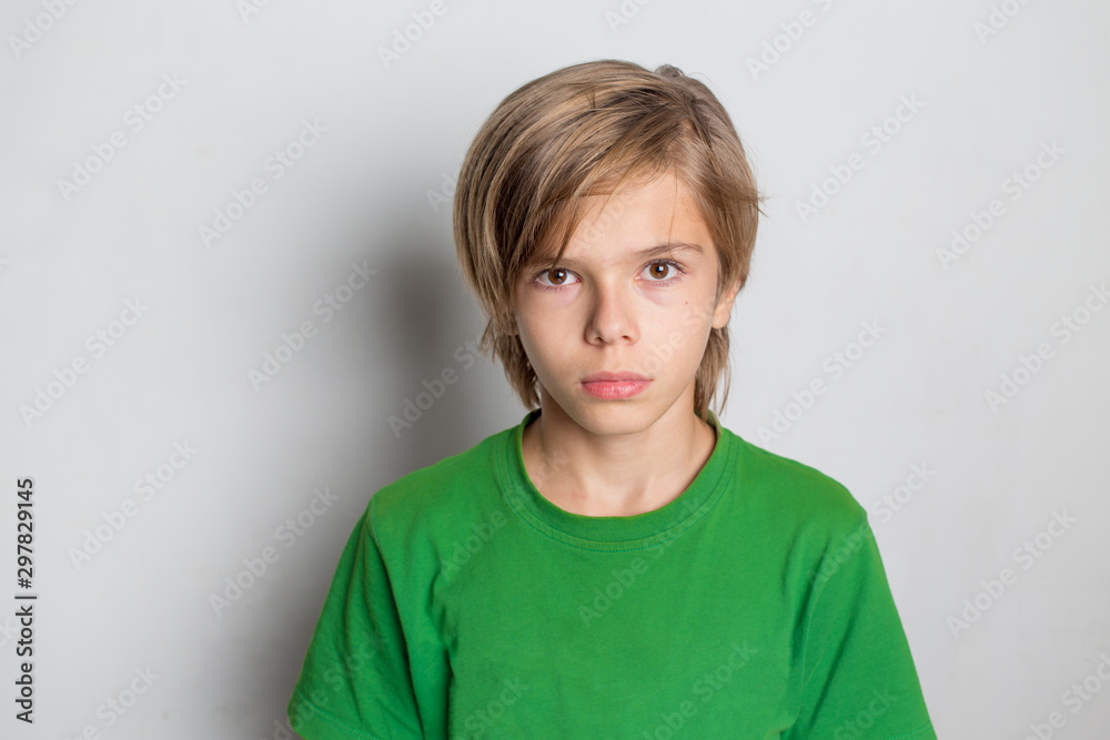 Photo of adorable young happy boy looking at camera. Isolated on the white background - obrazy, fototapety, plakaty 