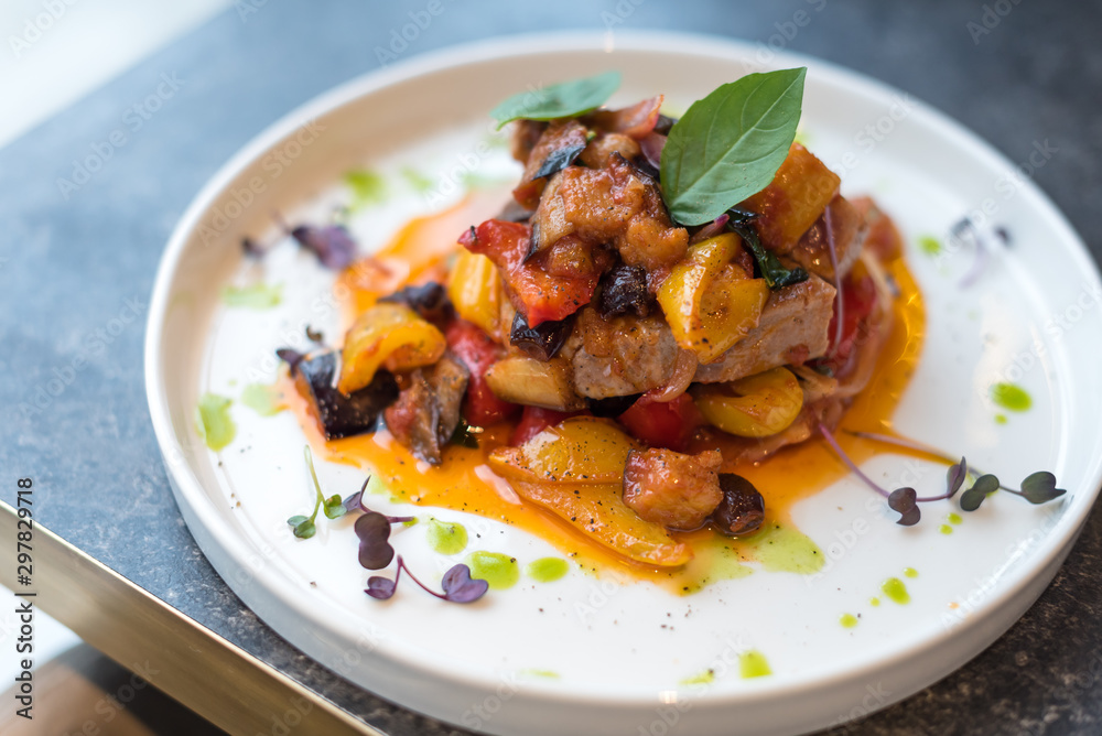 Grilled Tuna Steak with Stewed Vegetables on White Plate. Grilled Tuna Steak with Stewed Vegetables on White Plate.