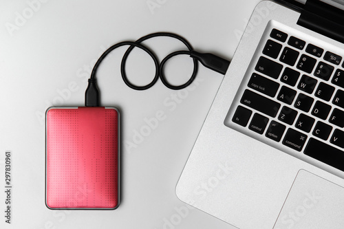 External Hard disk connect to laptop, External Hard disk and laptop computer, White background, Top view workspace photo