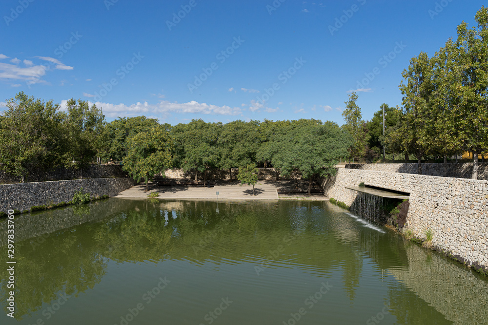 Beautiful green urban park. Public park with green grass fields, trees, waterways and pond. Parque de Cabecera, Valencia, Spain Beautiful green urban park. Public park with green grass fields, trees, waterways and pond. Parque de Cabecera, Valencia, Spain