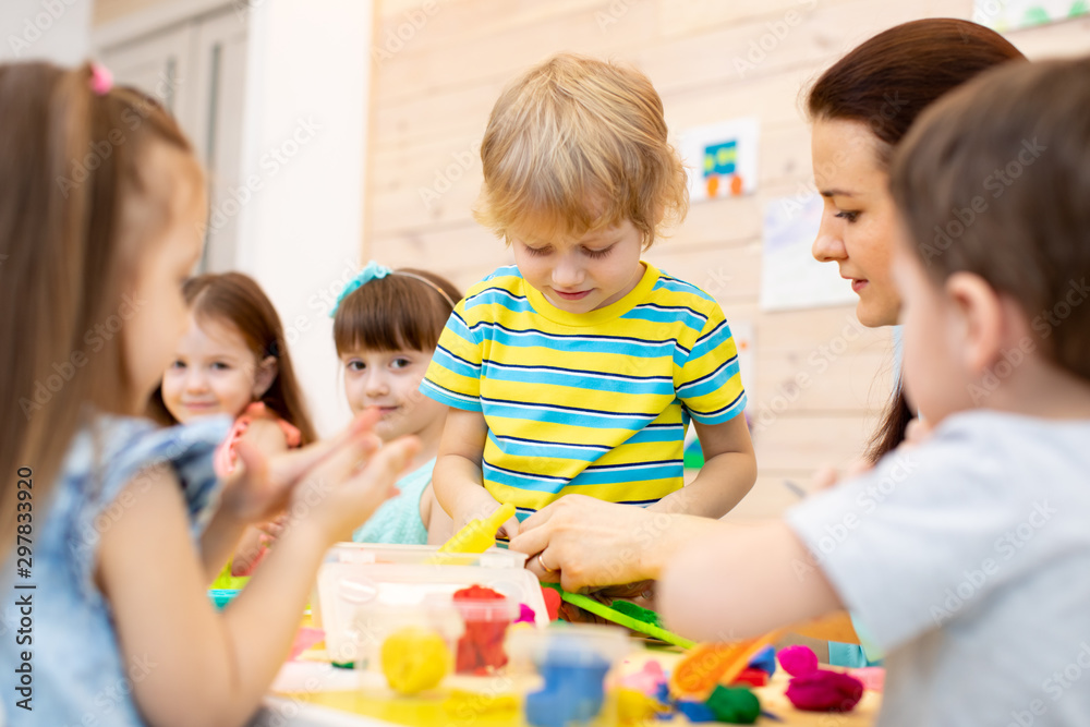 Kids playing with play clay in kindergarten or playschool Kids playing with play clay in kindergarten or playschool