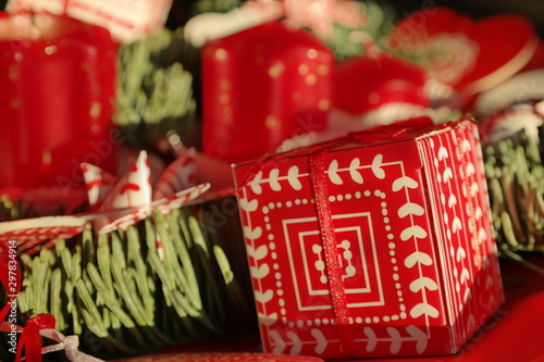 Red present and Christmas decorations. Red details and green pin tree details