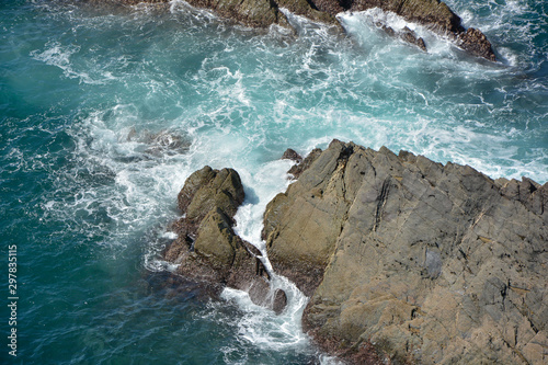 beautiful landscape of atlantic sea with rocks and waves and turquoise blue background, copy-space