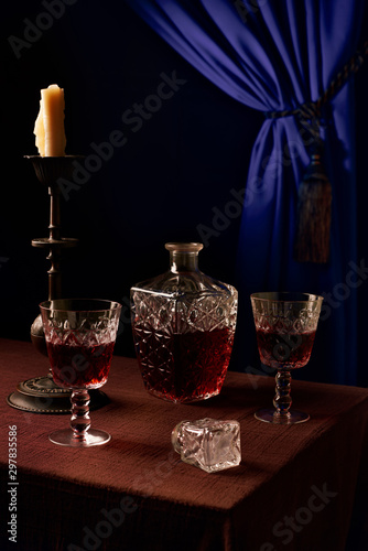 Table at restaurant for two. Glasses and a decanter with wine. A