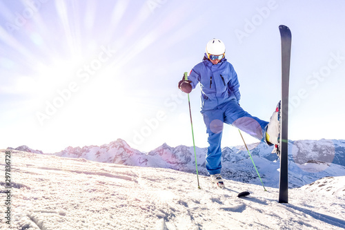 Obraz na płótnie Young skier on blue uniform at sunset on relax moment in french alps ski resort