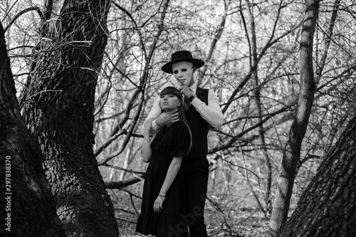 Masked maniac strangles a girl in the woods. Maniac attack in the woods on a girl.. Black and white photography.