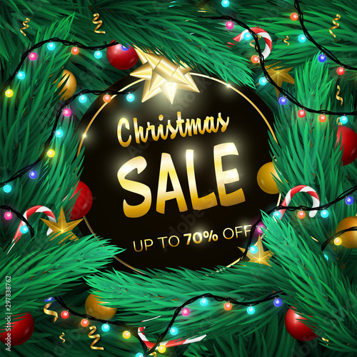 Christmas Sale promotion sale banner up to 70 percent off. Black circle placed on fir branches background © EGerman