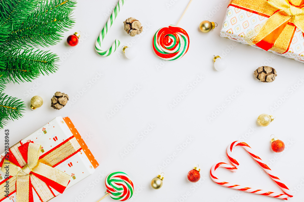 Fototapeta premium Christmas composition. Gift boxes, fir tree, cande cane on white background. Copy space, flat lay, top view Christmas or New Year concept.