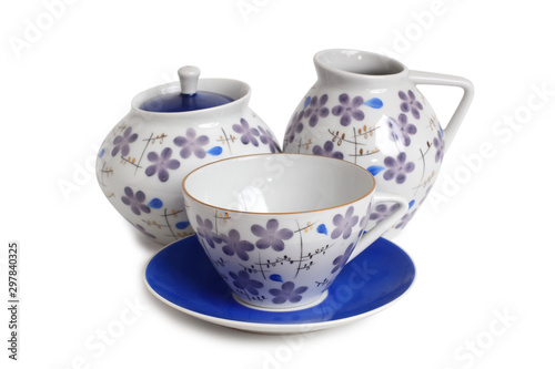 Antique porcelain tableware for tea on a white background