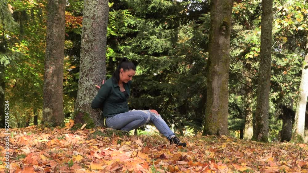 pretty brunette woman sitting in autumn park pretty brunette woman sitting in autumn park