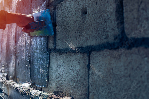 hand of worker plastering cement, Workers on the construction site professional, worker, equipment, construction site with sunset photo