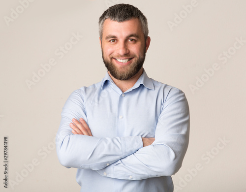 Portrait of confident bearded man over white background © Prostock-studio