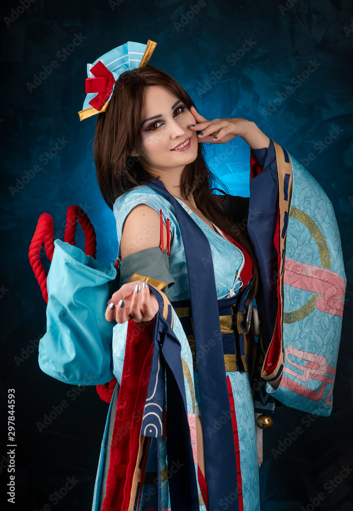 Beautiful smiling leggy busty cosplay girl wearing a stylized Japanese  kimono costume cheerfully posing on a blue background. foto de Stock |  Adobe Stock