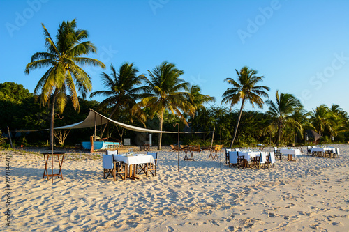 tropical beach with chairs and umbrellas Benguerra Island, Mozambique