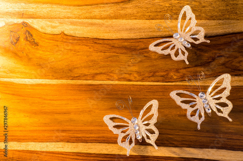Christmas or easter butterfly decorations on wooden table 